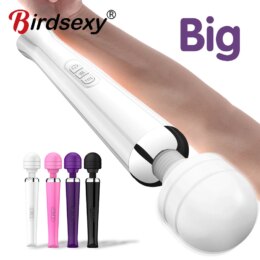 Four colorful handheld massagers next to an arm