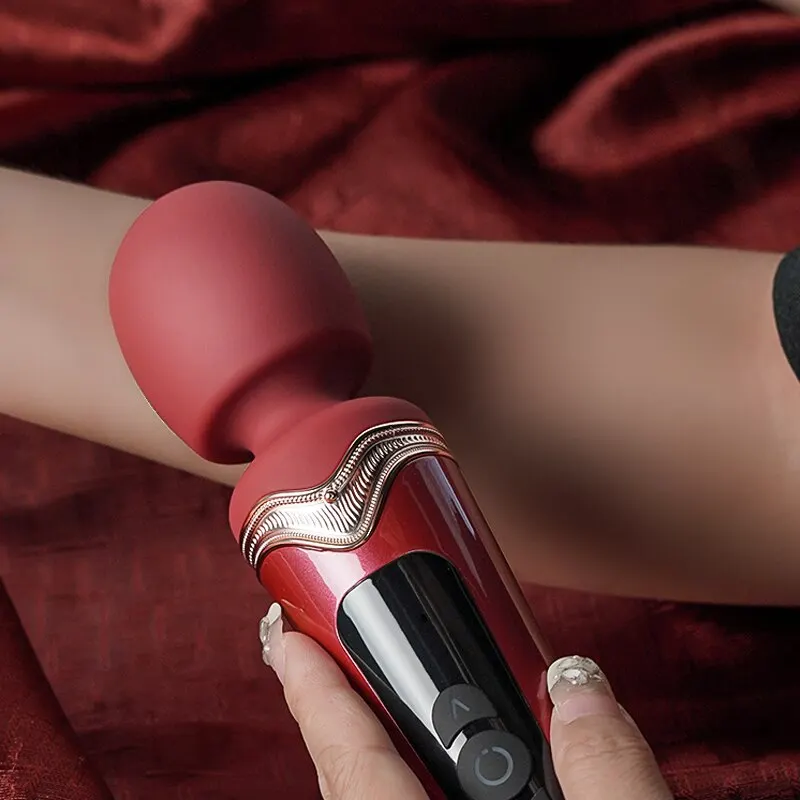 Red handheld massager on arm
