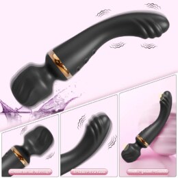 Black handheld massager with textured head, gold accents.