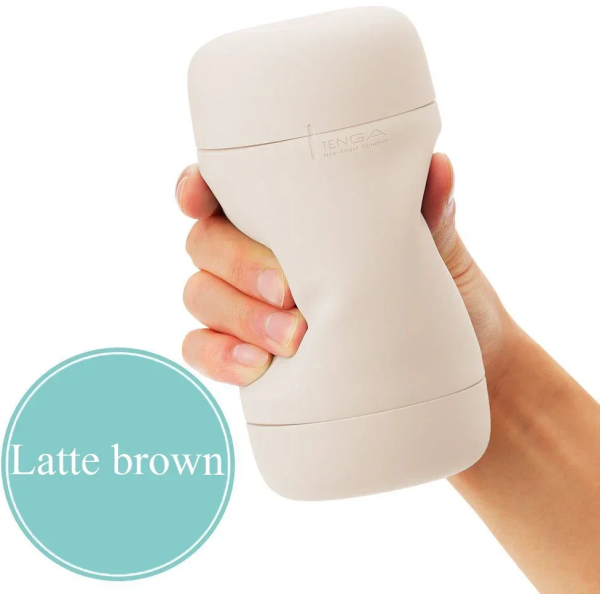 Hand holding beige cylindrical object