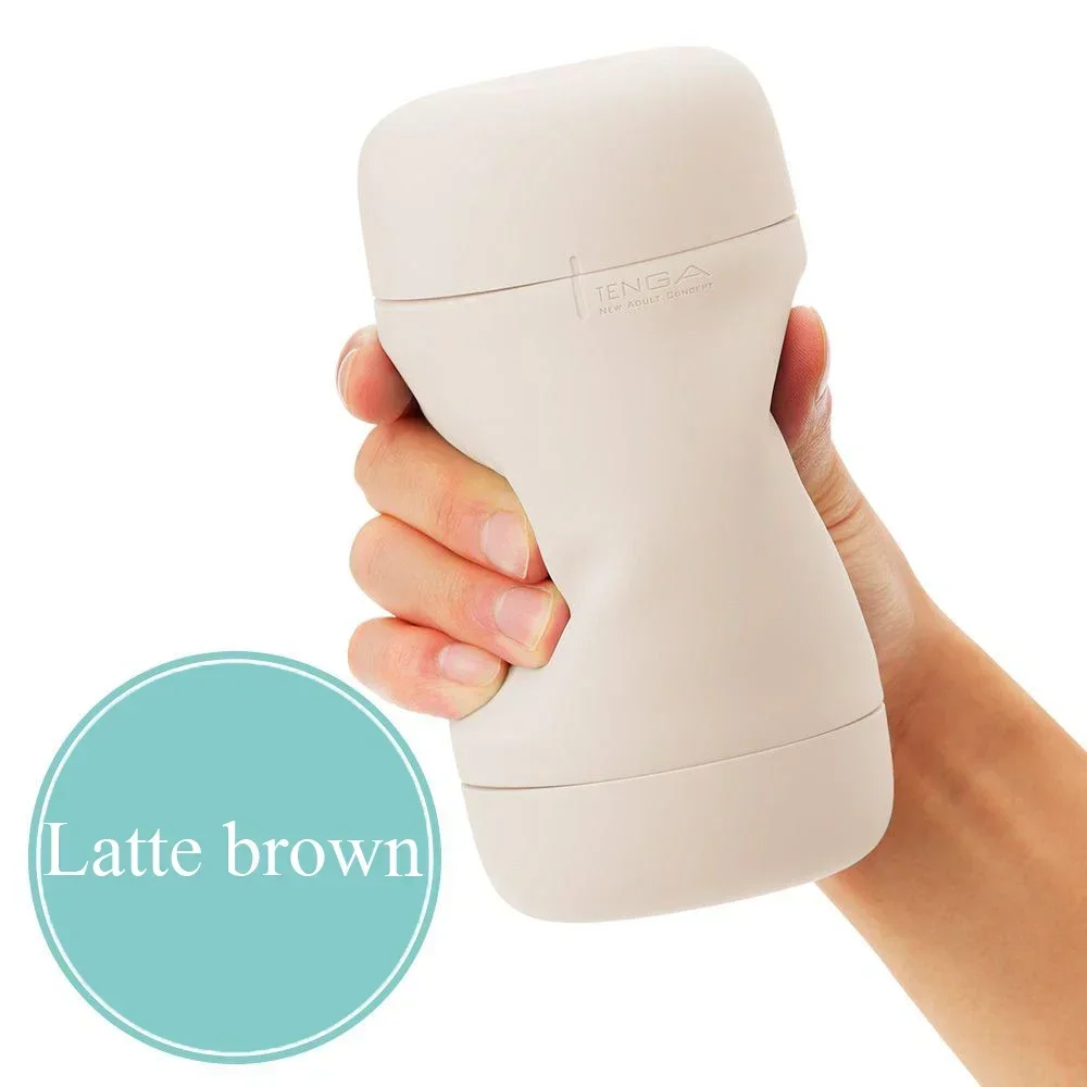 Hand holding latte brown TENGA device