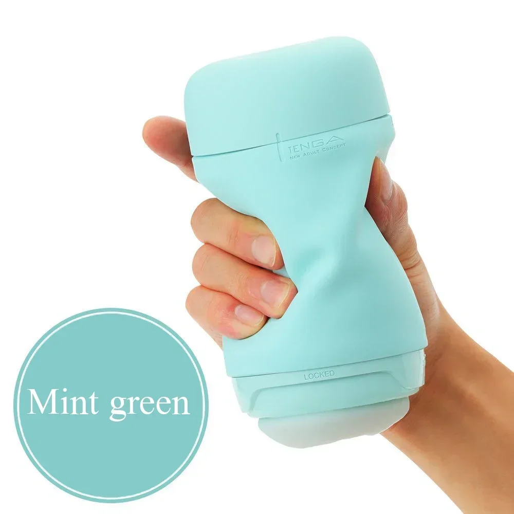 Hand holding mint green Tenga device