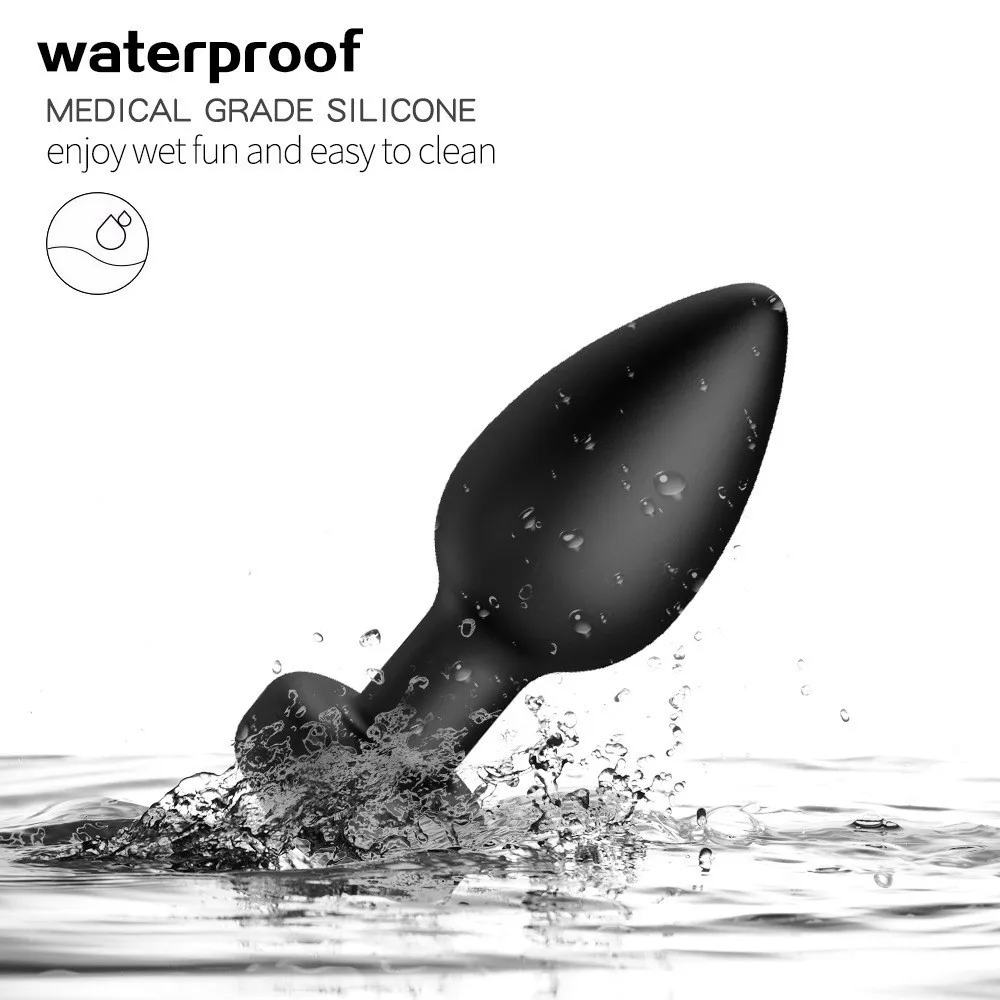 Black silicone adult toy splashing in water